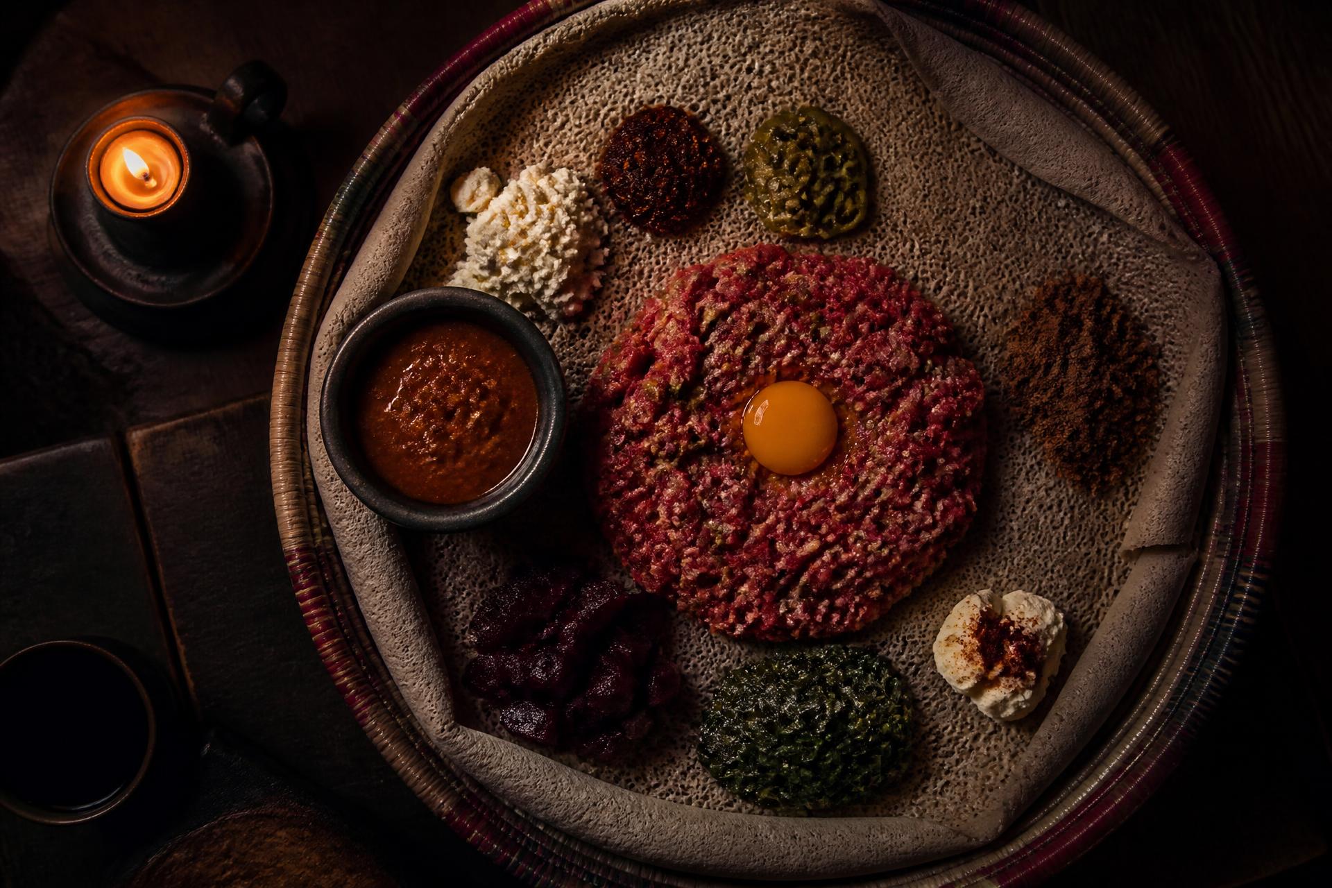 Traditional Ethiopian raw meat platter served on injera